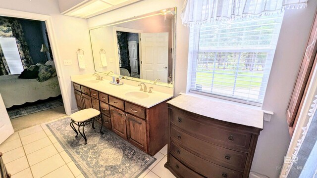 bathroom featuring tile patterned flooring, vanity, and plenty of natural light