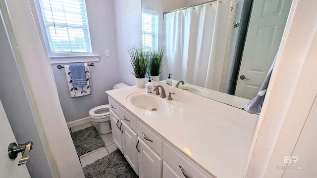 bathroom with vanity, toilet, and tile patterned floors