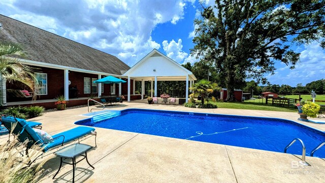 view of swimming pool featuring a patio area