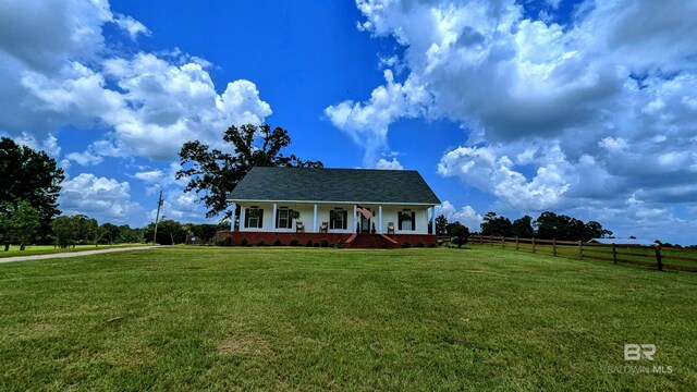 view of front facade with covered porch and a front yard