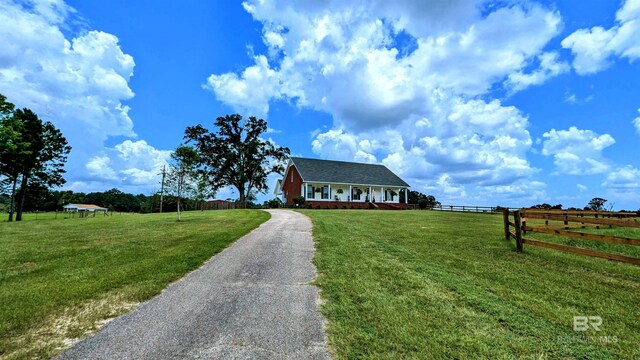 view of front of property featuring a rural view and a front yard