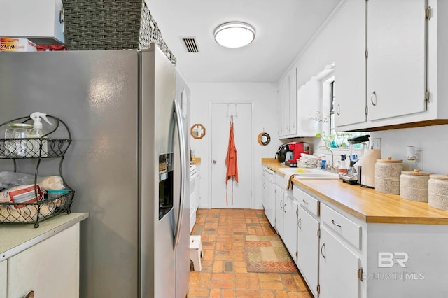 45 Caisson Trce, Spanish Fort, AL 36527 - kitchen featuring stainless steel refrigerator with ice dispenser, brick patterned floors, light countertops, and white cabinets