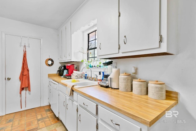 45 Caisson Trce, Spanish Fort, AL 36527 - kitchen with brick patterned flooring, dishwasher, light countertops, and white cabinetry