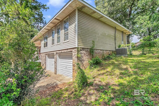 45 Caisson Trce, Spanish Fort, AL 36527 - view of side of home with brick siding, driveway, and a garage