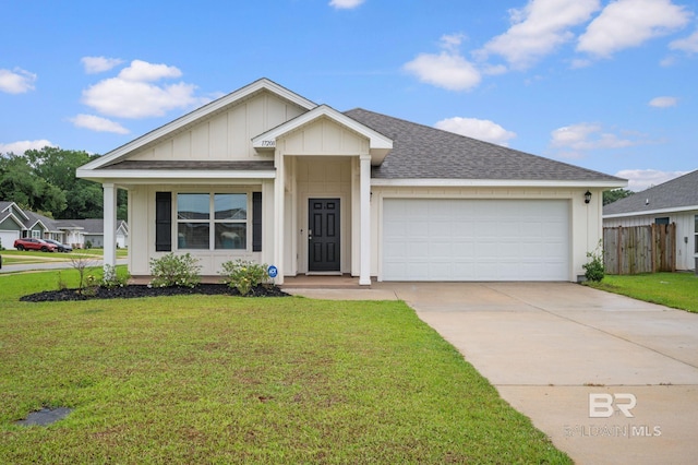 17208 Muse St, Loxley, AL 36551 - ranch-style home featuring a garage, driveway, a shingled roof, and board and batten siding