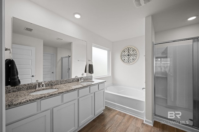 17208 Muse St, Loxley, AL 36551 - full bath with a stall shower, a garden tub, double vanity, wood finished floors, and recessed lighting