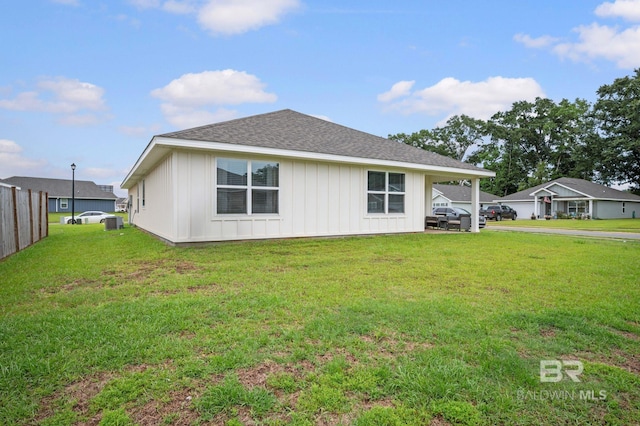17208 Muse St, Loxley, AL 36551 - rear view of house with board and batten siding, a lawn, roof with shingles, and central AC unit