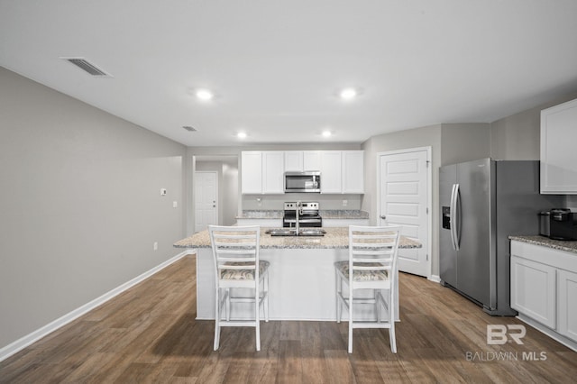 17208 Muse St, Loxley, AL 36551 - kitchen featuring appliances with stainless steel finishes, dark wood-type flooring, baseboards, an island with sink, and recessed lighting
