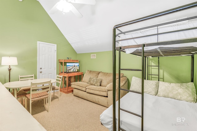 carpeted bedroom with a ceiling fan and lofted ceiling