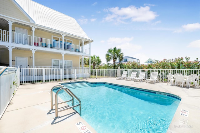 community pool featuring a patio and fence