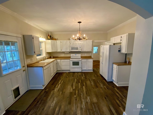 kitchen featuring sink, decorative light fixtures, white appliances, white cabinets, and ornamental molding