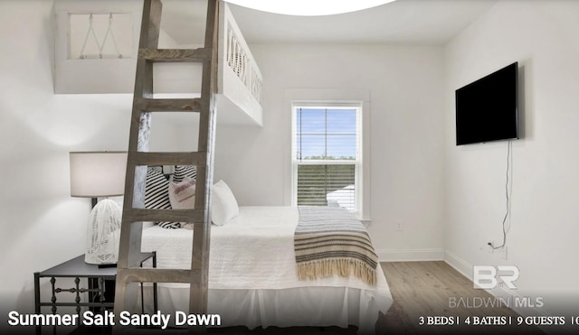 2760 Salt Dr, Orange Beach, AL 36561 - bedroom featuring baseboards and wood finished floors