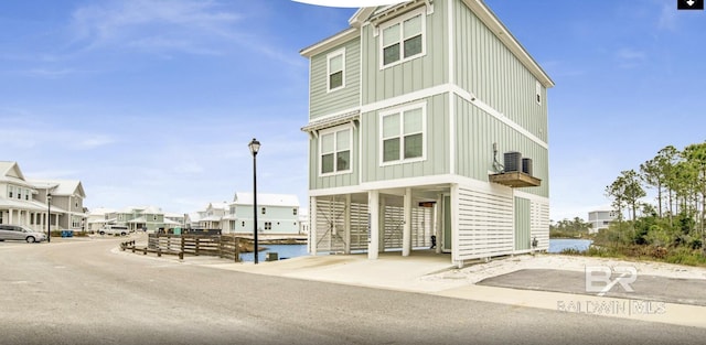 2760 Salt Dr, Orange Beach, AL 36561 - exterior space featuring cooling unit, a carport, a residential view, and board and batten siding