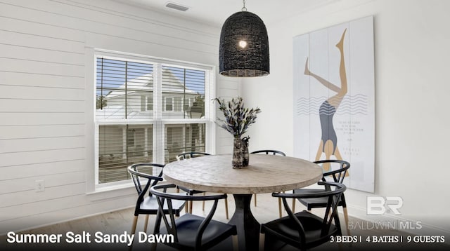 2760 Salt Dr, Orange Beach, AL 36561 - dining area with wood walls, baseboards, wood finished floors, and visible vents