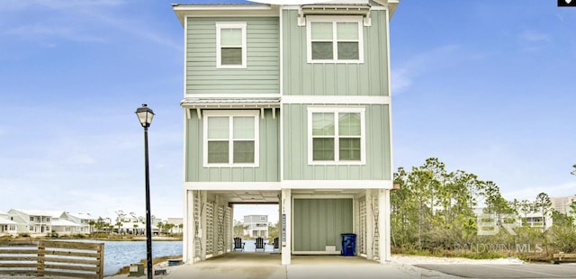 2760 Salt Dr, Orange Beach, AL 36561 - coastal home featuring driveway, a carport, board and batten siding, and a water view