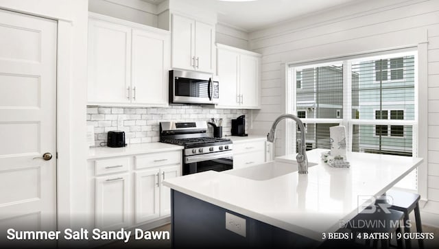 2760 Salt Dr, Orange Beach, AL 36561 - kitchen with white cabinets, decorative backsplash, a sink, and appliances with stainless steel finishes