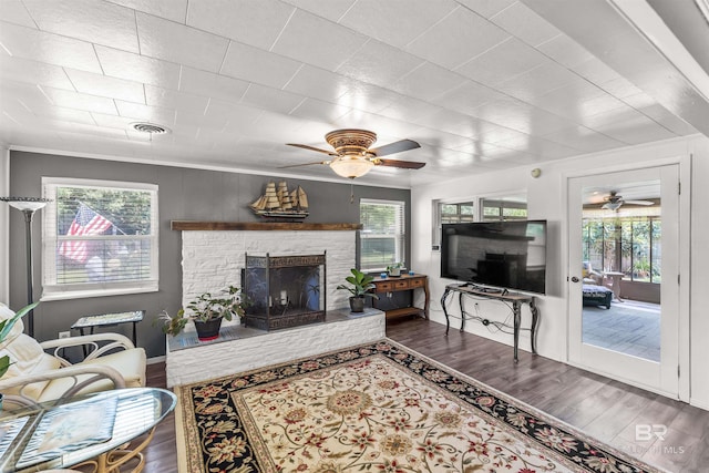 7410 Helton Dr, Foley, AL 36535 - living area featuring ceiling fan, wood finished floors, a stone fireplace, and baseboards