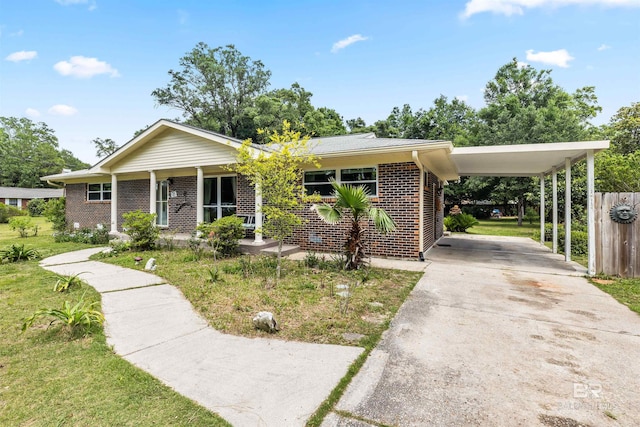 7410 Helton Dr, Foley, AL 36535 - ranch-style house featuring brick siding, concrete driveway, a carport, a porch, and fence