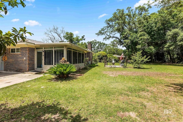 7410 Helton Dr, Foley, AL 36535 - view of green lawn with a sunroom