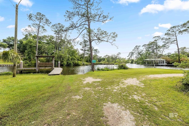 7410 Helton Dr, Foley, AL 36535 - view of green lawn with a water view and a dock