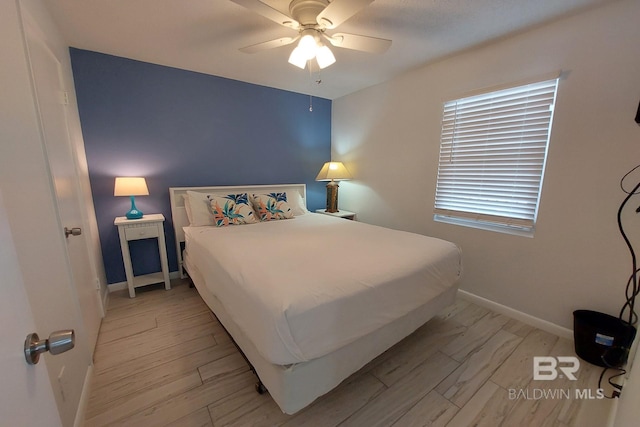 bedroom with ceiling fan and light wood-type flooring