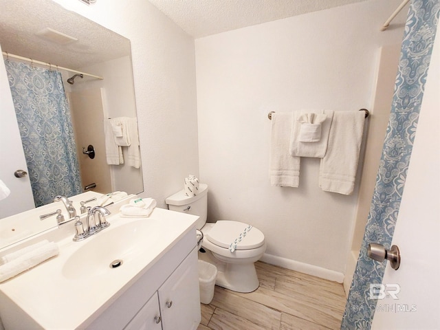 full bathroom featuring toilet, vanity, a textured ceiling, shower / bath combo with shower curtain, and wood-type flooring