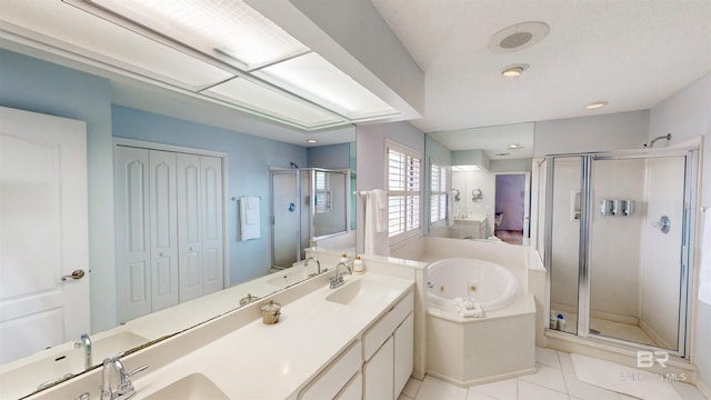 full bath featuring tile patterned floors, a sink, a shower stall, double vanity, and a whirlpool tub