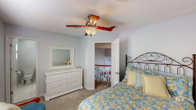 carpeted bedroom featuring connected bathroom, baseboards, visible vents, and a textured ceiling