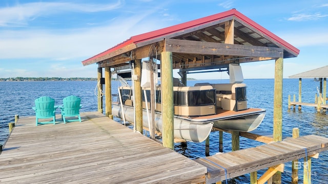 view of dock with boat lift and a water view