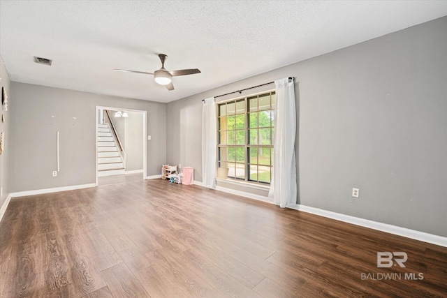 unfurnished room with ceiling fan, hardwood / wood-style flooring, and a textured ceiling