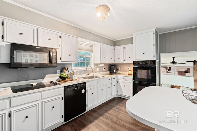 kitchen with sink, black appliances, a textured ceiling, ornamental molding, and white cabinets