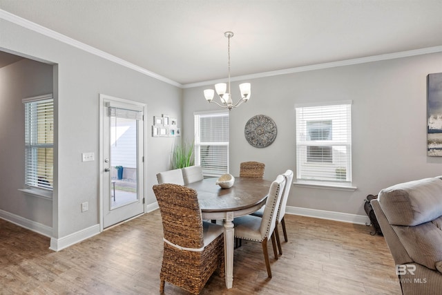 dining area featuring ornamental molding, plenty of natural light, and a notable chandelier