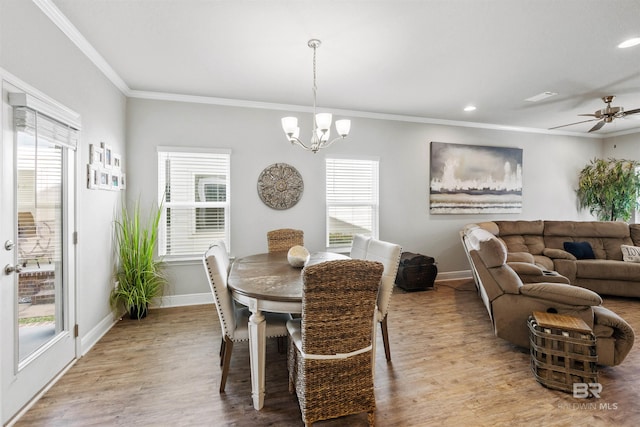 dining area featuring crown molding, ceiling fan with notable chandelier, and light hardwood / wood-style floors