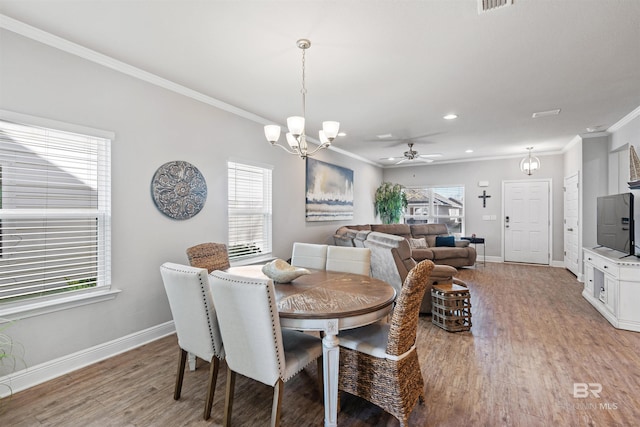 dining room featuring ceiling fan with notable chandelier, hardwood / wood-style floors, and ornamental molding