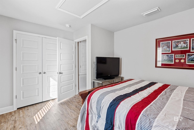 bedroom featuring light wood-type flooring and a closet