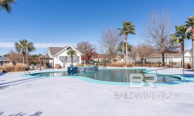 view of swimming pool with a patio area, pool water feature, and a pergola