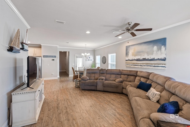 living room with light wood-type flooring, crown molding, and ceiling fan with notable chandelier