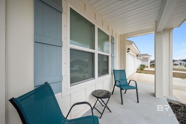 view of patio / terrace with a porch and a garage