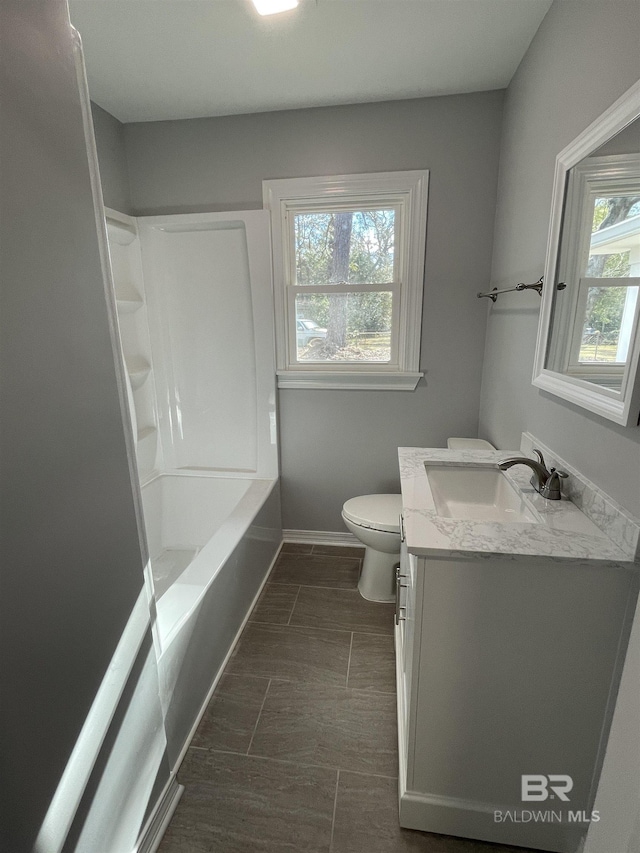 full bathroom featuring shower / bath combination, vanity, and toilet