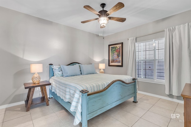 bedroom with ceiling fan, baseboards, and light tile patterned flooring