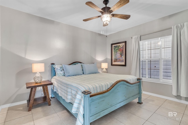 bedroom with ceiling fan, baseboards, and light tile patterned flooring