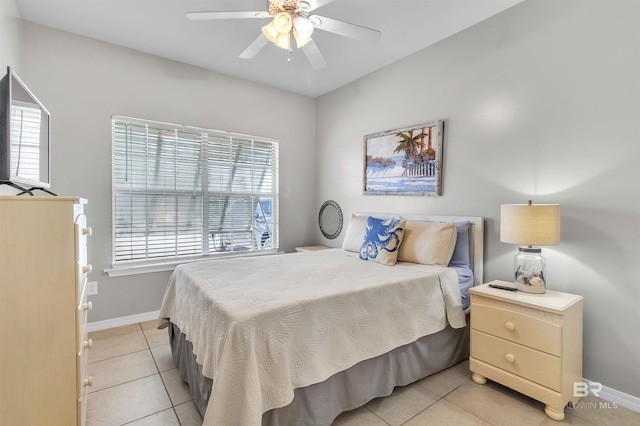 bedroom featuring ceiling fan, baseboards, and light tile patterned flooring