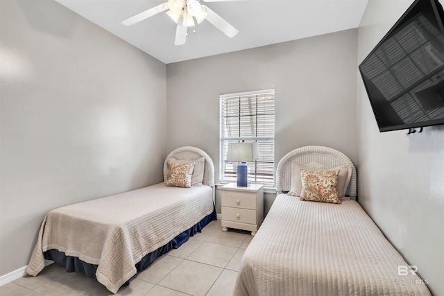 bedroom with a ceiling fan, baseboards, and light tile patterned floors