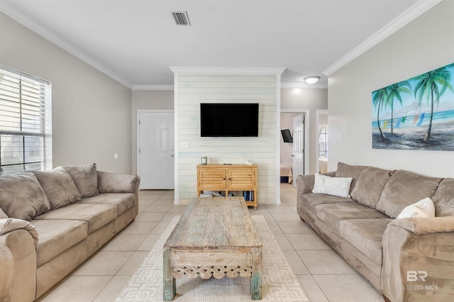 living area with light tile patterned floors, ornamental molding, visible vents, and a healthy amount of sunlight