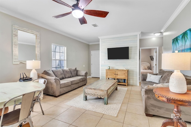 living area featuring a ceiling fan, light tile patterned flooring, visible vents, and crown molding