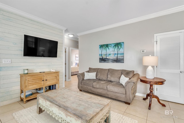 living room featuring ornamental molding, light tile patterned flooring, and baseboards