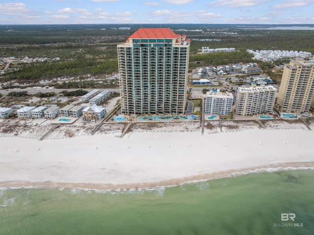 drone / aerial view featuring a water view and a view of the beach