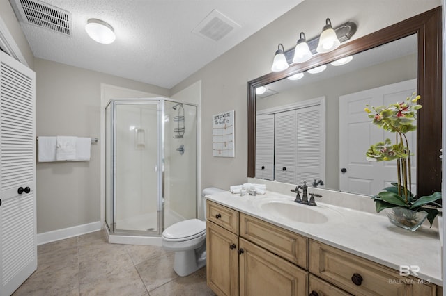 bathroom featuring a stall shower, visible vents, and toilet