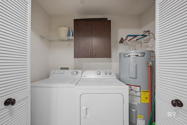 laundry area with water heater, cabinet space, and washing machine and clothes dryer