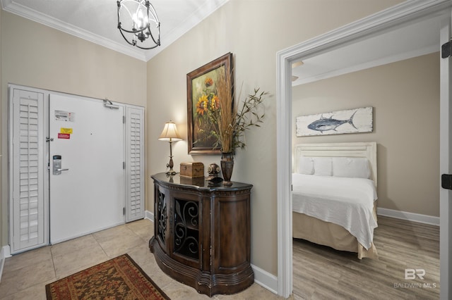 foyer entrance featuring baseboards, a chandelier, and crown molding